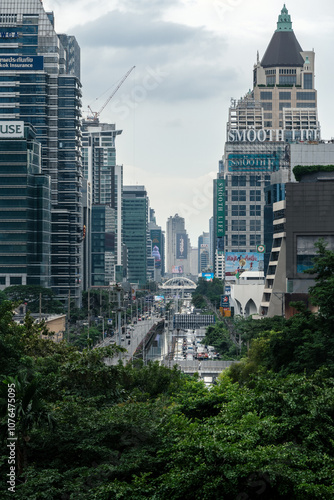 Photography Bangkok city viewed from green space, Sathon Road, lined with skyscrapers, corpo