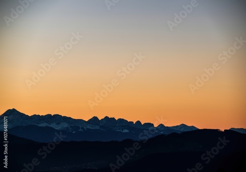 Scenic mountain silhouette at sunset with clear sky