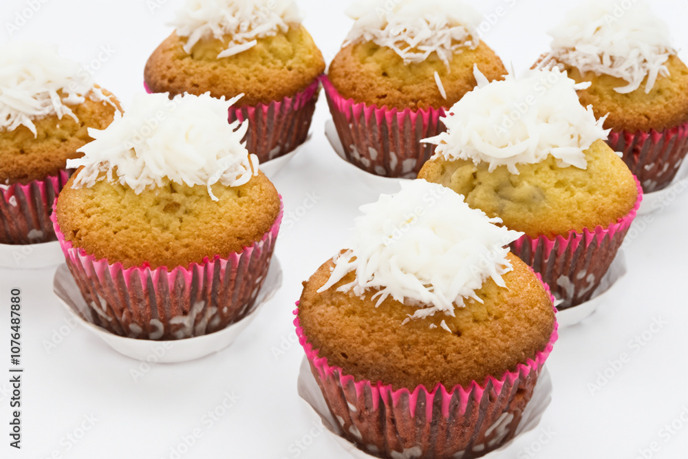 And cupcakes on a white. dessert sweet delicious concept. a white cupcake with coconut flakes on a white . small fluffy cupcakes with coconut and flakes on a lifestyle white. And cupcakes on a white. dessert sweet delicious concept. a white cupcake with coconut flakes on a white . small fluffy cupcakes with coconut and flakes on a lifestyle white.