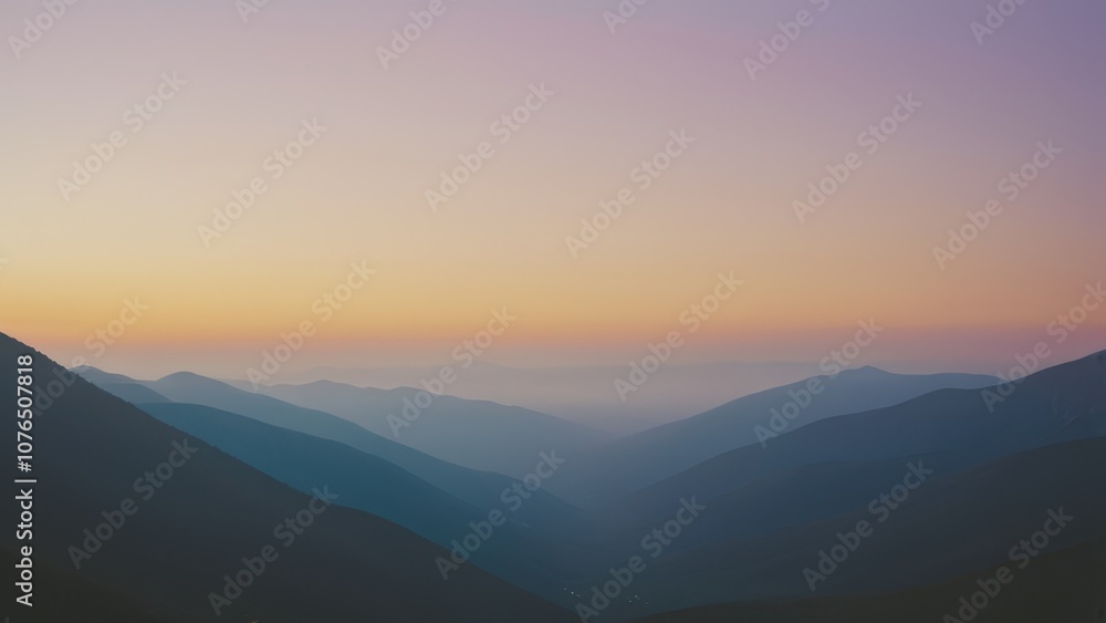 Obraz premium Breathtaking mountain landscape with soft light illuminating rolling hills and peaks, perfect for nature and travel themes