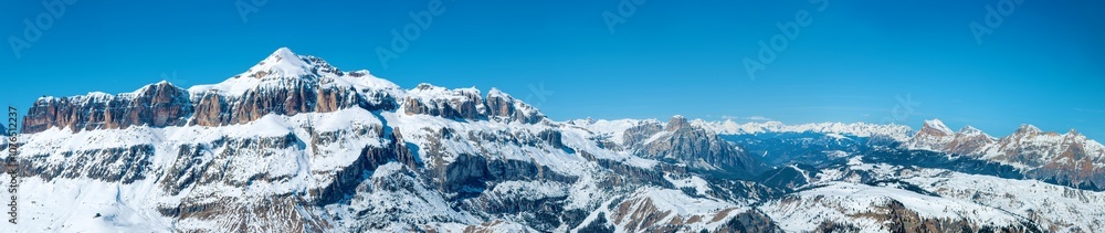 Dolomites in Italy. Wide panorama with Sella group mountain massif in winter. Famous ski and snowboard region with popular resorts around and famous Sella Ronda ski trail carousel around Sella
