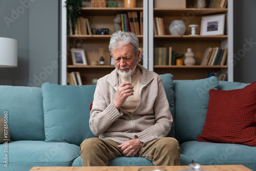 Quadro em tela Senior man, widower or divorced, feeling sad, worry, abandoned and depressed, sitting alone at home, crying