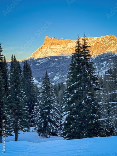 Scenic view of Heiligkreuzkofel mountain Sas dla Crusc in the Dolomites, South Tyrol, Italy in winter at sunset against blue sky photo