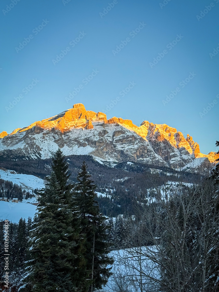 Scenic view of Piz Lavarela (links) and Piz Cunturines (right) in the Dolomites, South Tyrol, Italy in winter at sunset against blue sky