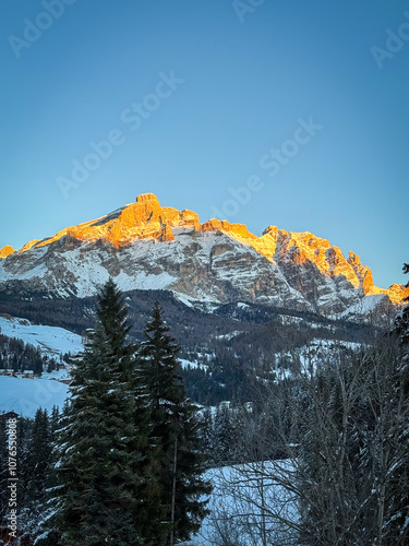 Obraz na płótnie Scenic view of Piz Lavarela (links) and Piz Cunturines (right) in the Dolomites, South Tyrol, Italy in winter at sunset against blue sky w salonie