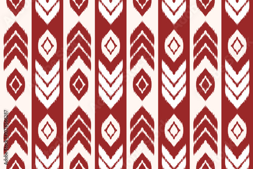 Ikat repeating pattern with a red and white color scheme. The pattern consists of vertical stripes with a chevron (zigzag) motif and diamond shapes in the center
