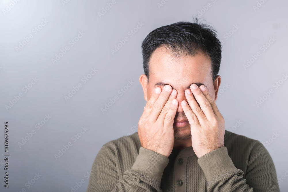 Man covers his eyes with both hands, symbolizing the vision complications from diabetes, known as diabetic retinopathy. Highlights the importance of awareness and eye health in diabetes care Man covers his eyes with both hands, symbolizing the vision complications from diabetes, known as diabetic retinopathy. Highlights the importance of awareness and eye health in diabetes care