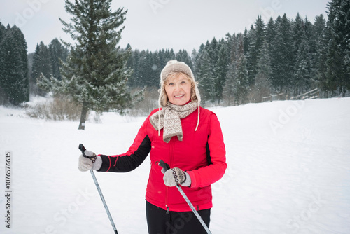 senior active woman outdoots portrarit - skiing in forest