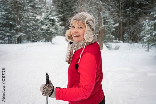 senior active woman outdoots portrarit - skiing in forest
