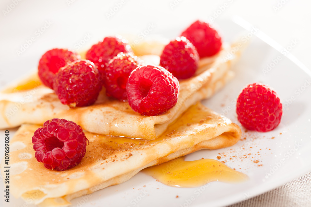 Delicious pancakes with fresh raspberries and honey Delicious pancakes with fresh raspberries and honey
