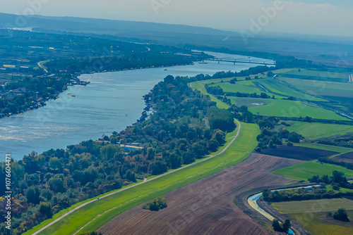 Aerial view of valley with farm fields, pond and Danube river. High quality photo