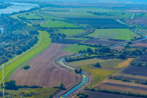 Aerial view of valley with farm fields, pond and Danube river. High quality photo