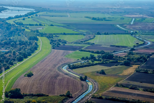 Aerial view of valley with farm fields, pond and Danube river. High quality photo