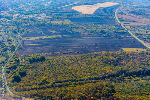 Aerial view of valley with farm fields, pond and Danube river. High quality photo