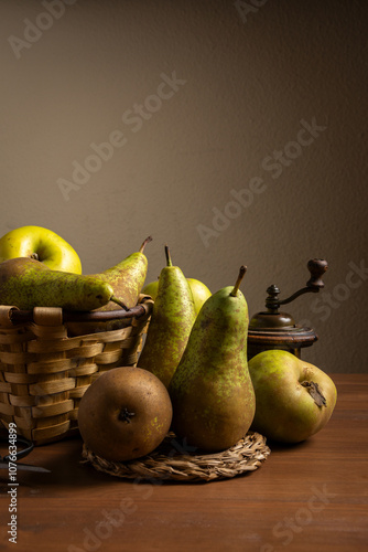 View of pears in a basket and on a wooden table, vertically, with copy space