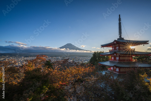The Chureito pagoda with a red maple tree on Autumn and sunset view 