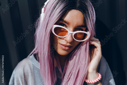 Young beauty girl purple hair make selfie on smartphone, happy face, outdoor hipster portrait on the street, smile happy face, listen music on headphones, Amsterdam street, dance, player,photo concept