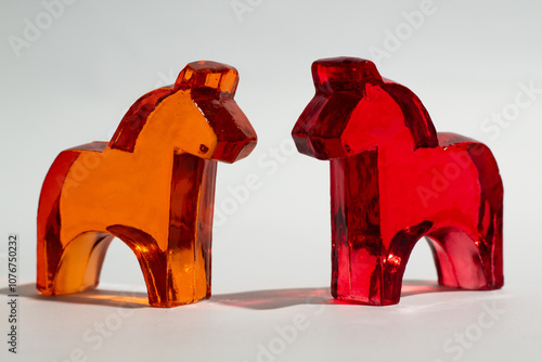 Red and orange horse figure made from glass on white background