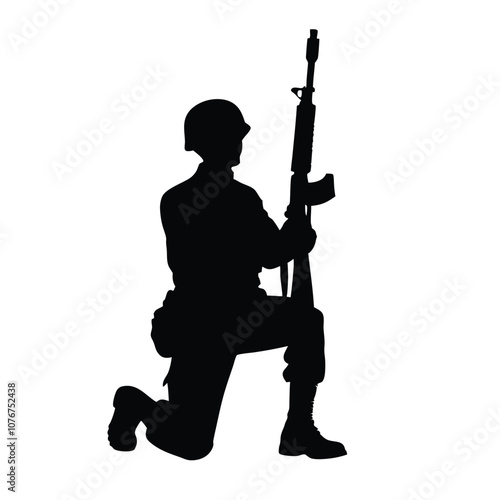 A soldier is kneeling down and holding a rifle. He is wearing a helmet. The soldier is in a military uniform