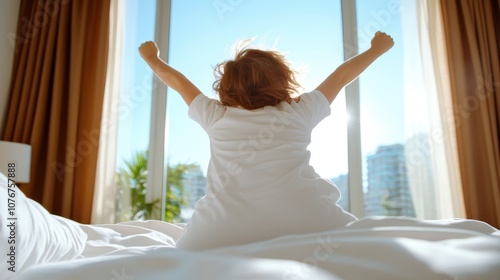 Wallpaper Mural A child happily stretches their arms wide, welcoming the morning sunlight. The view through the large window offers an open and bright urban landscape scene. Torontodigital.ca