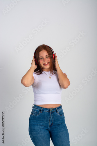 woman listening to music smiling while dancing isoaled on a white background photo