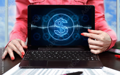 Businesswoman pointing on laptop screen with dollar sign