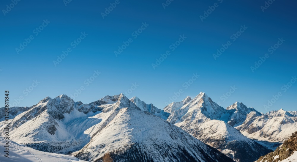 Fototapeta premium Snowy Mountain Peaks under a Blue Sky