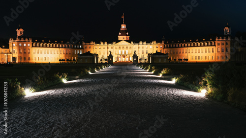 Night panorama of Karlsruhe Castle with the lights illuminating the avenue in the park. Karlsruhe, Germany, Baden-Württemberg.