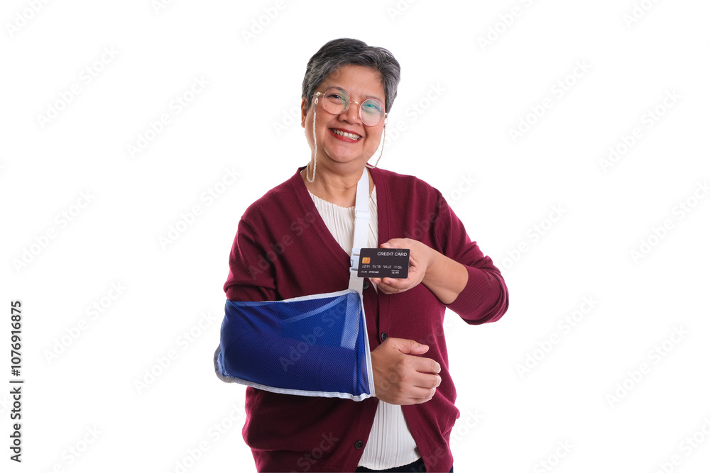 Smiling elderly woman with a blue arm sling, holding a card, isolated on a white background. Smiling elderly woman with a blue arm sling, holding a card, isolated on a white background.