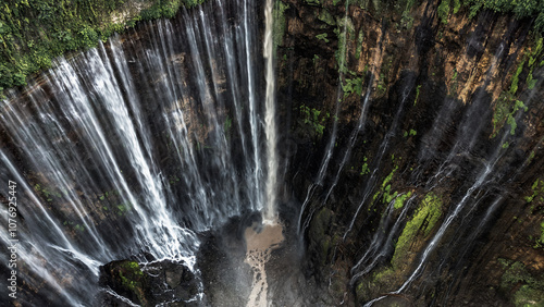 Photography of Tumpak Sewu waterfall. Trip to Java Island in Indonesia. Aerial photography with drone. Incredible landscape. photo