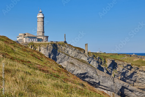 Cape Mayor lighthouse on the rocky coast in Santander, Spain. photo