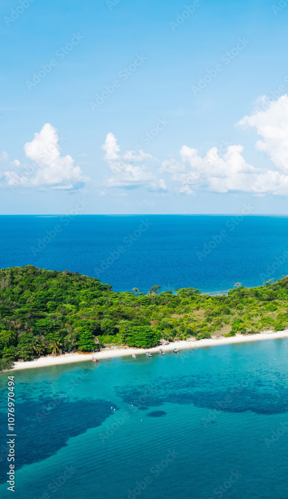Obraz premium Aerial scenery view of picturesque island with crystal azure water and green vegetation.Bird's eye view of paradise beach shoreline, beautiful touristic destination for summer vacations,