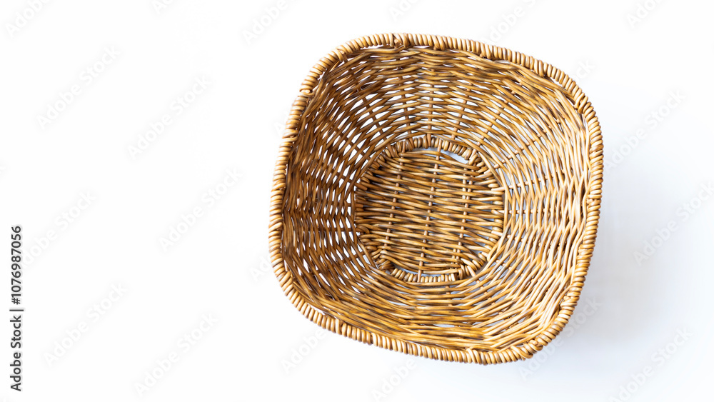 Fototapeta premium Empty wicker basket on a white background. Top view.