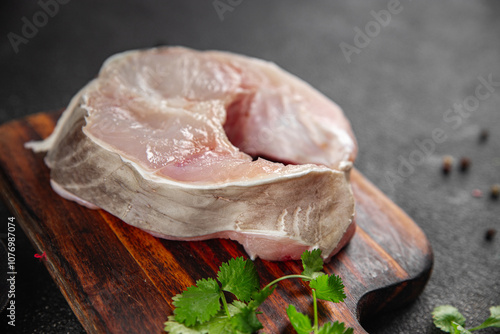 Eel steak European conger raw fish piece portion tasty food dish Fresh gourmet food background on the table  pescetarian diet vegetarian rustic food copy space top view photo