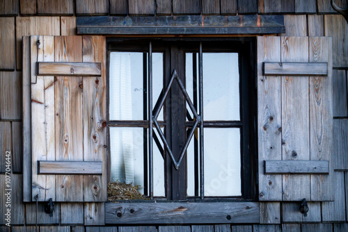 a bird nest outside on a windowsill from a old wood hut photo