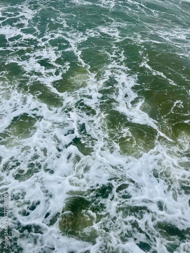 Stormy sea surface, natural green sea water with foam, sea surface background