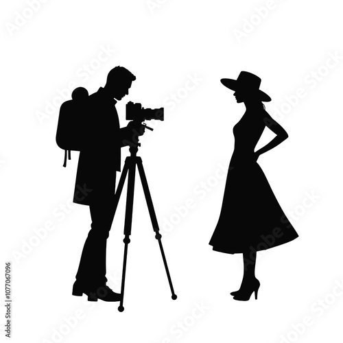 A silhouette of a cameraman operating a standing camera on a tripod,