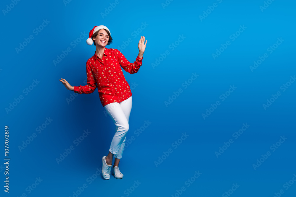 Fototapeta premium Full size photo of pretty young woman dancing empty space christmas festive time isolated on blue color background