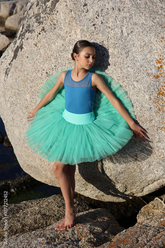 Young brunette ballet dancer by the ocean
