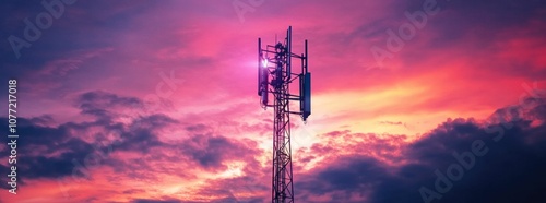 Wallpaper Mural Sunset over a telecommunications tower, showcasing a vibrant pink and purple sky, with clouds adding depth and contrast for a striking visual effect Torontodigital.ca