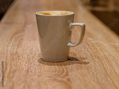 White ceramic cup of cappuccino on the bar