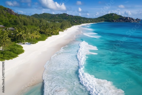 Turquoise waves gently lapping the pristine white sand beach of praslin island, seychelles photo