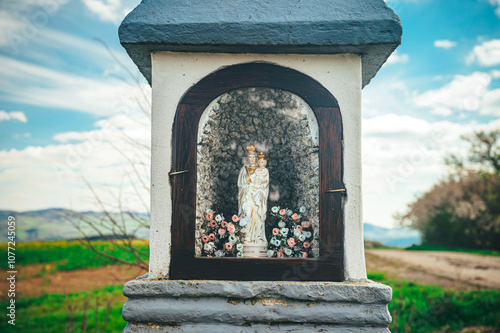 Statue of St. Mary Behind Glass in a Christian Chapel, A Sacred Space for Prayer and Rest photo