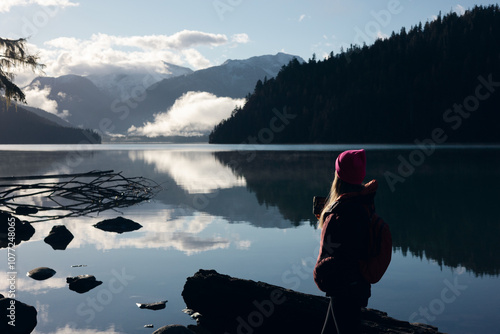 Woman looking over a mountain lake photo