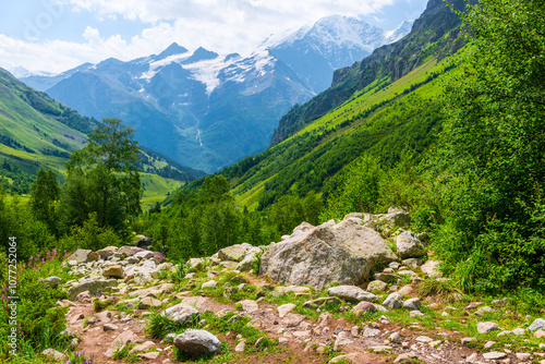 Beautiful high mountain landscape with green slopes and large stones. Caucasus, Elbrus region.