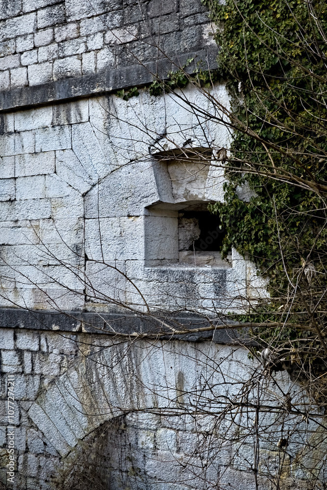 Tagliata della Scala: the facade of the nineteenth-century fortress with an artillery loophole. Primolano, Veneto, Italy.