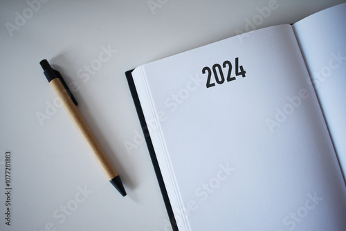 2024 calendar book and pencil on desk