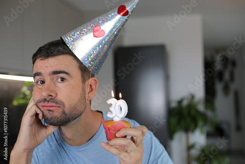 Sad man celebrating his 30th birhtday  photo