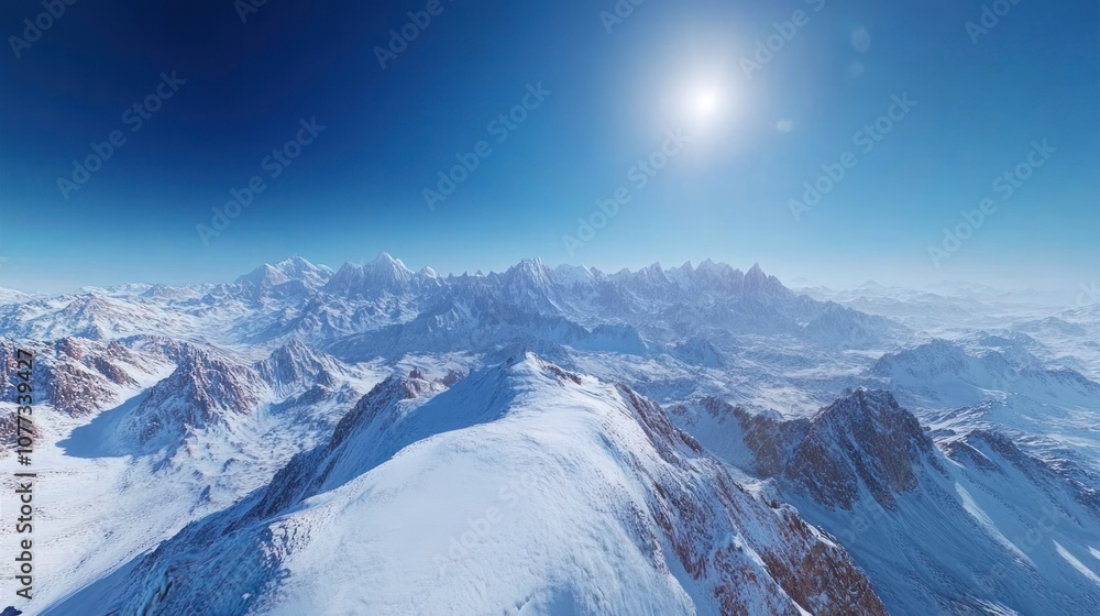 Obraz premium A panoramic view of snow-capped mountains under a bright blue sky with the sun shining brightly. The mountains are covered in white snow and the sky is a clear blue.
