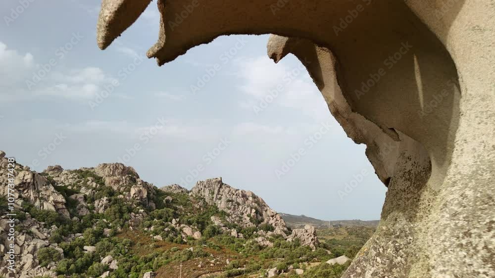 Exploring the majestic Eagle Rock formation in Sardinia during golden hour